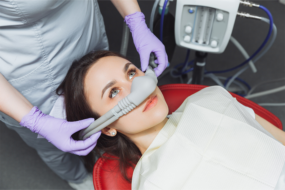 Dentist in the High Park neighbourhood at High Park Dental Care providing sedation dentistry with Nitrous Oxide to a relaxed patient during treatment
